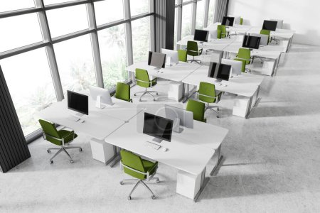 Photo for Top view of coworking interior with pc desktops on tables in row, grey concrete floor. White workspace with minimalist furniture and panoramic window on tropics. 3D rendering - Royalty Free Image