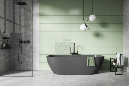 Modern bathroom with freestanding dark bathtub, green tiled wall background, and minimalist design. Concept of simple and serene interior.  3D Rendering