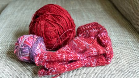 Photo for Woolen knitted socks, knitting yarn and knitting needles, knitted fashion, needlework clothing, winter hobby, needlework concept. Homemade crochet, needlework - Royalty Free Image