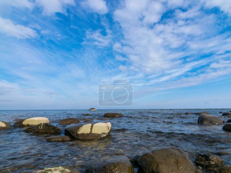 Photo for Blue seascape with many stones on a sunny day, Kaltene sea shore, Latvia - Royalty Free Image