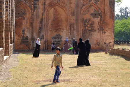 Photo for December 18 2022 - Bidar, Karnataka in India: Unidentified muslim women playing cricket in the area of Bahmani Tombs - Royalty Free Image