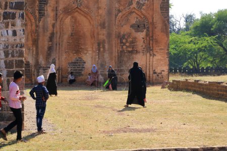 Photo for December 18 2022 - Bidar, Karnataka in India: Unidentified muslim women playing cricket in the area of Bahmani Tombs - Royalty Free Image