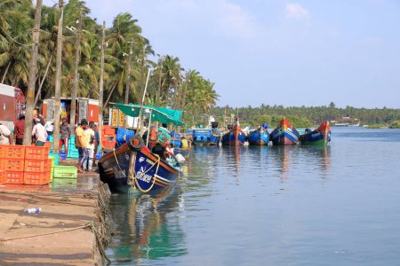 Photo for December 28 2022 - Kannur, Kerala in India: Fishing Harbour Palacode with colorful fishing boats after fishing at noon - Royalty Free Image