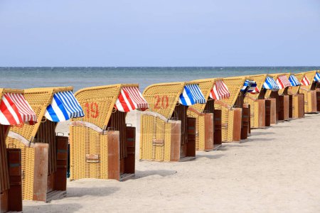 Photo for Hooded beach chairs at the baltic sea in timmendorf in germany, island poel - Royalty Free Image