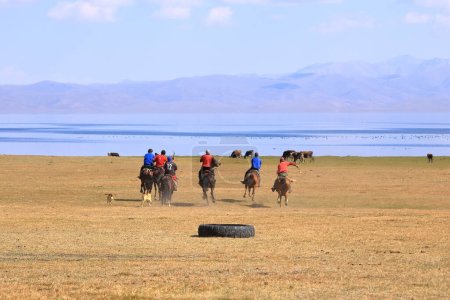 Téléchargez les photos : 24 août 2023 - Lac Song kol au Kirghizistan : Les locaux jouent au hamburu (ulak tartysh), jeu de chevaux traditionnel, avec mannequin en cuir au lieu d'une carcasse de chèvre - en image libre de droit