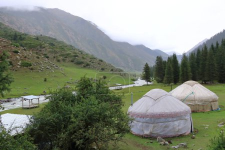 the landscape near Jeti Oguz gorge with yurts and green meadows on a cloudy day