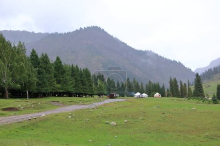 the landscape near Jeti Oguz gorge with yurts and green meadows on a cloudy day