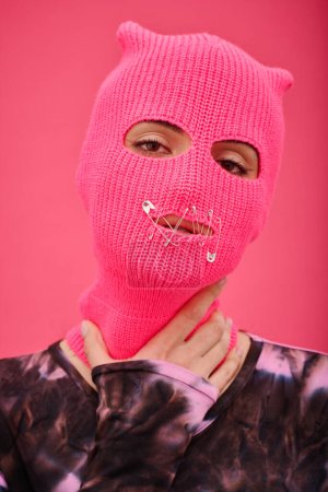 Photo for Portrait of young woman wearing pink balaclava with sewed mouth having no rights to speak - Royalty Free Image