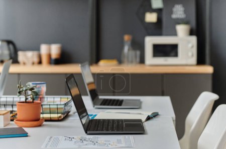 Close-up of two laptop computers standing on table for online work at modern office