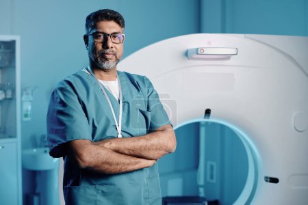 Portrait of professional doctor adjusting MRI scanner settings for next patient