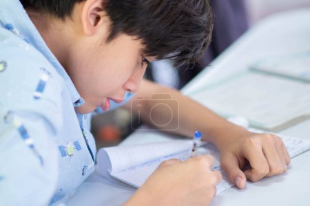 Kid boy doing homework with stress panic at home