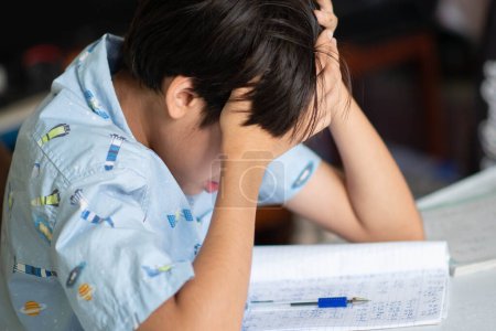 Kid boy doing homework with stress panic at home