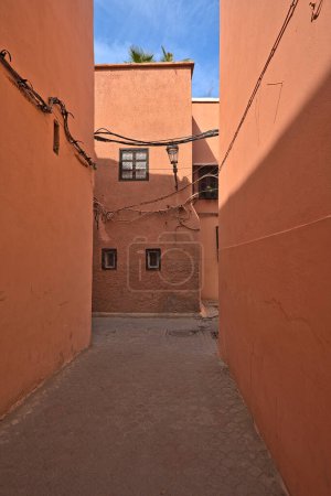 Photo for Red colored houses in Marrakesh and an alley, exact location unknown - Royalty Free Image
