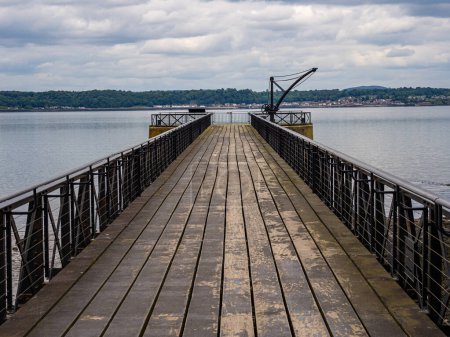 Cast iron pier with a wooden decking. It extends 73m from a drawbridge in the west wall of Blackness Castle to a concrete pier in the Forth - a total distance of 79m. Erected in 1867-70 by the Government in order to transfer muntions from storage 