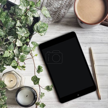 Photo for Cup of coffee with ipad and plant. flat lay reading - Royalty Free Image