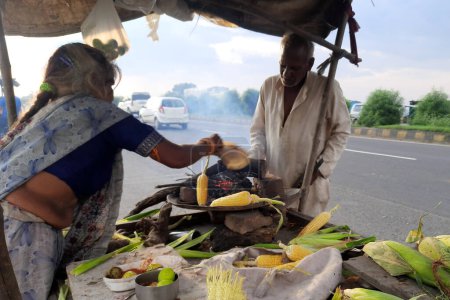 Photo for 30-09-2021 Dewas, M.P. Inia. roadside corn bar, Roasted and Spicy Corn, roadside female vendor selling roasted maize - Royalty Free Image
