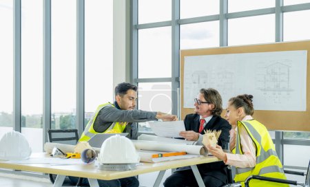 Photo for Engineer team is meeting to inspect the construction blueprint drawings, work plan and distribute work before starting the building, - Royalty Free Image
