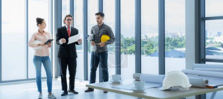 Photo for Engineer team meeting to inspect the construction blueprint drawings, work plan and distribute work before starting the building. - Royalty Free Image