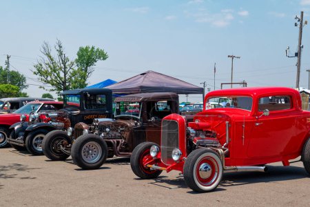 Photo for Lebanon, Tennessee USA - June 09, 2023  Variety of vintage cars turned into hot rods and rat rods parked together in a row at a car show on a bright sunny day in early summertime - Royalty Free Image