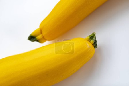 Photo for Two vibrant yellow zucchini on a white background - Royalty Free Image