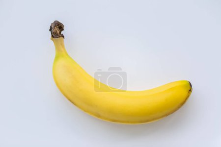 Photo for A bright yellow banana on white background - Royalty Free Image