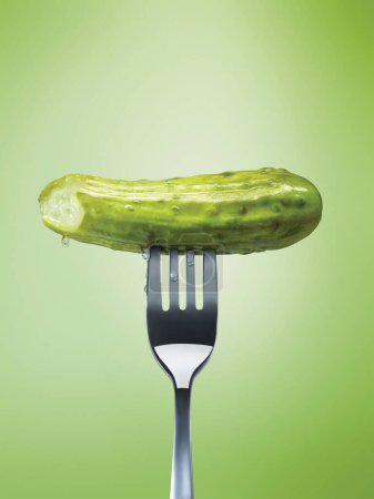 Close-up of a pickle on a fork