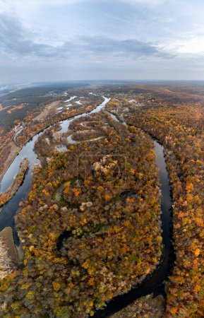 Aerial Siverskyi Donets river vertical panorama in autumn with wooded riverbanks and scenic sky in Ukraine