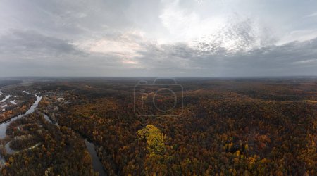 Aerial autumn river valley with woods on hills, panorama of colorful autumnal Ukraine countryside