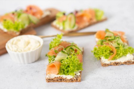 Photo for Bread with cucumber and salmon. healthy food - Royalty Free Image