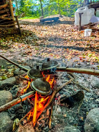 Photo for Popcorn is roasted in the woods over a campfire. - Royalty Free Image