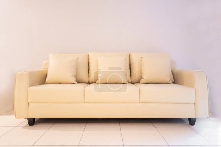 Photo for Sofa in white cream color with 3 pillows and 3 seats - Royalty Free Image