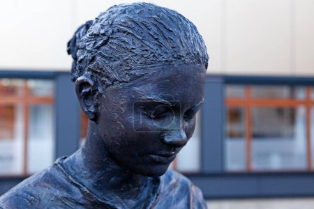 Photo for Umea, Norrland Sweden - November 11, 2022: a statue depicting a young girl closing her eyes - Royalty Free Image