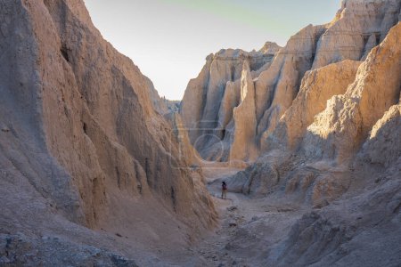 The view of the rugged yet beautiful Notch Trail at Badlands National Park in South Dakota at sunset. The parks 244,000-acres protect an expanse of mixed-grass prairie and striking geologic deposits.