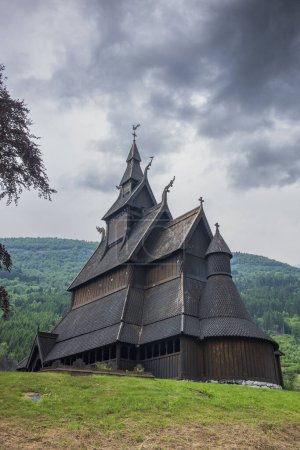 Photo for Hopperstad Stave Church, an ancient wooden stave church dating back to the 1100s, located in Roysane, Norway, photographed with moody storm clouds on an overcast summer day. - Royalty Free Image