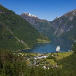 Geiranger, Norway is a small tourist village at the head of the Geirangerfjord, which is a branch of the large Storfjord and is home to spectacular scenery and listed as a UNESCO World Heritage Site.