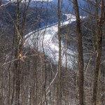 The Bouchoux Trail near Long Eddy NY is a 5.5-mile hiking path that hugs the Delaware River, photographed under a few inches of snow during the winter. A view from the ledge of the river valley. 