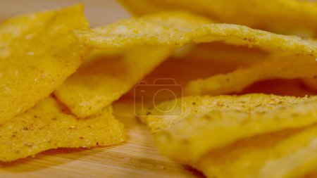 Photo for MACRO, DOF: Golden tortilla crisps sprinkled with salt and Latin spices lie stacked in a big party heap. Detailed close up shot reveals the exotic spice sprinkled on top of a heap tortilla chips. - Royalty Free Image