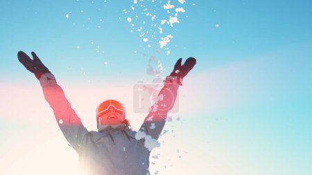 Foto de LENS FLARE, CLOSE UP, COPY SPACE: Cheerful young woman snowboarding in the gorgeous Slovenian mountains throws a handful of snow on sunny winter day. Female tourist plays with fresh snow in wintertime - Imagen libre de derechos