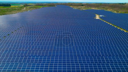 Photo for AERIAL: Enormous field with solar collectors for sustainable electric production. Innovative solar-powered technology for alternative energy production. Modern use of technology for sustainable future - Royalty Free Image