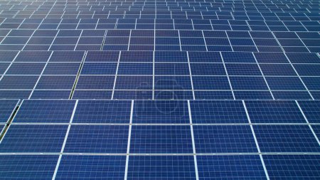 Photo for AERIAL: Pattern of solar panels with solar cells as a part of solar power plant. Innovative solar-powered technology for alternative energy production. Modern use of technology for sustainable future - Royalty Free Image