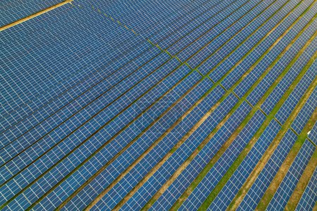 Photo for AERIAL: Endless pattern of lined up solar collectors for generating electricity. Enormous field of solar panels for sustainable energy production. Innovative use of technology for sustainable future. - Royalty Free Image