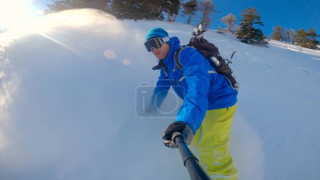 Photo for Snowboarder enjoying freeriding fresh powder snow in snowy mountains. Male rider snowboarding and spraying on freshly fallen snow. Extreme outdoor activity for adrenaline winter holiday. - Royalty Free Image