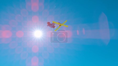 Photo for Freestyle skier performs grab trick while jumping big air kicker. Extreme athlete in action at snow park in ski resort. Winter action full of adrenaline in snow-covered alpine mountains - Royalty Free Image