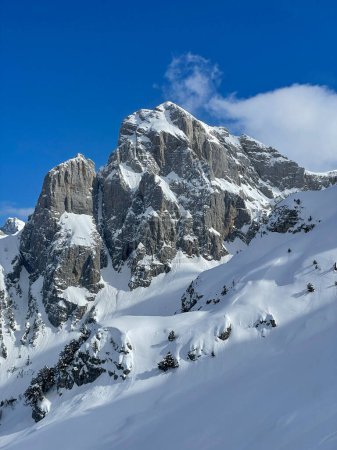 Téléchargez les photos : Picturesque rocky mountain peak in winter sunlight covered with fresh snow. Breath-taking location for mountain adventures in pristine and untouched alpine terrains of snow-covered Albanian Alps. - en image libre de droit