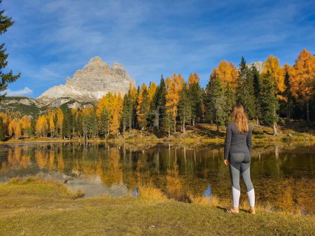 Photo for COPY SPACE: Woman poses in front of Lago d'Antorno and fall colored landscape - Royalty Free Image