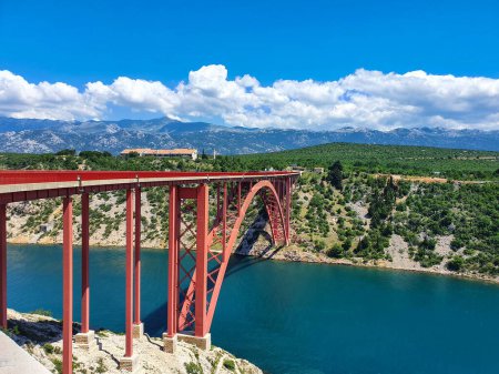 Photo for Large modern red metal bridge crosses the Adriatic sea in Maslenica, Croatia. - Royalty Free Image