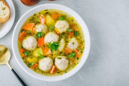 Photo for Meatballs soup. Chicken turkey vegetables meatballs soup with carrots and potatoes. Top view, copy space - Royalty Free Image