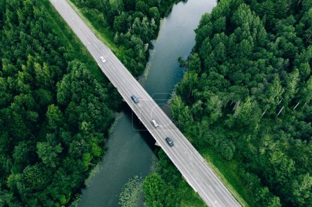 Photo for Aerial view of road over the blue river and green woods in summer Finland - Royalty Free Image