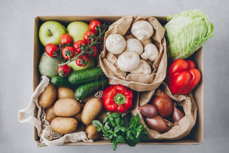 Photo for Vegetables. Organic food box delivery. Tomatoes, potatoes, cucumbers, radish, basil, onions, paprika, lettuce. Fresh farm veggies. - Royalty Free Image