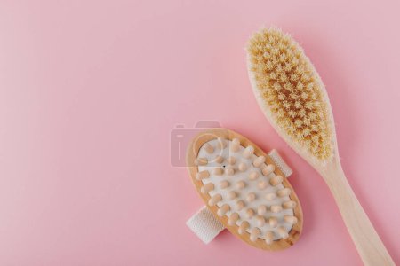 Photo for Massage brush. Natural wooden brushes for body massage on pink background. Eco-friendly lifestyle concept and zero waste - Royalty Free Image